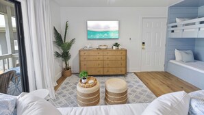 A room with a ceiling fan, a wooden dresser, a television, a door, and a bunk bed. - My Blue Heaven 30A Getaway - Beach Access, Pools & Prime 30A Location (Santa Rosa Beach)