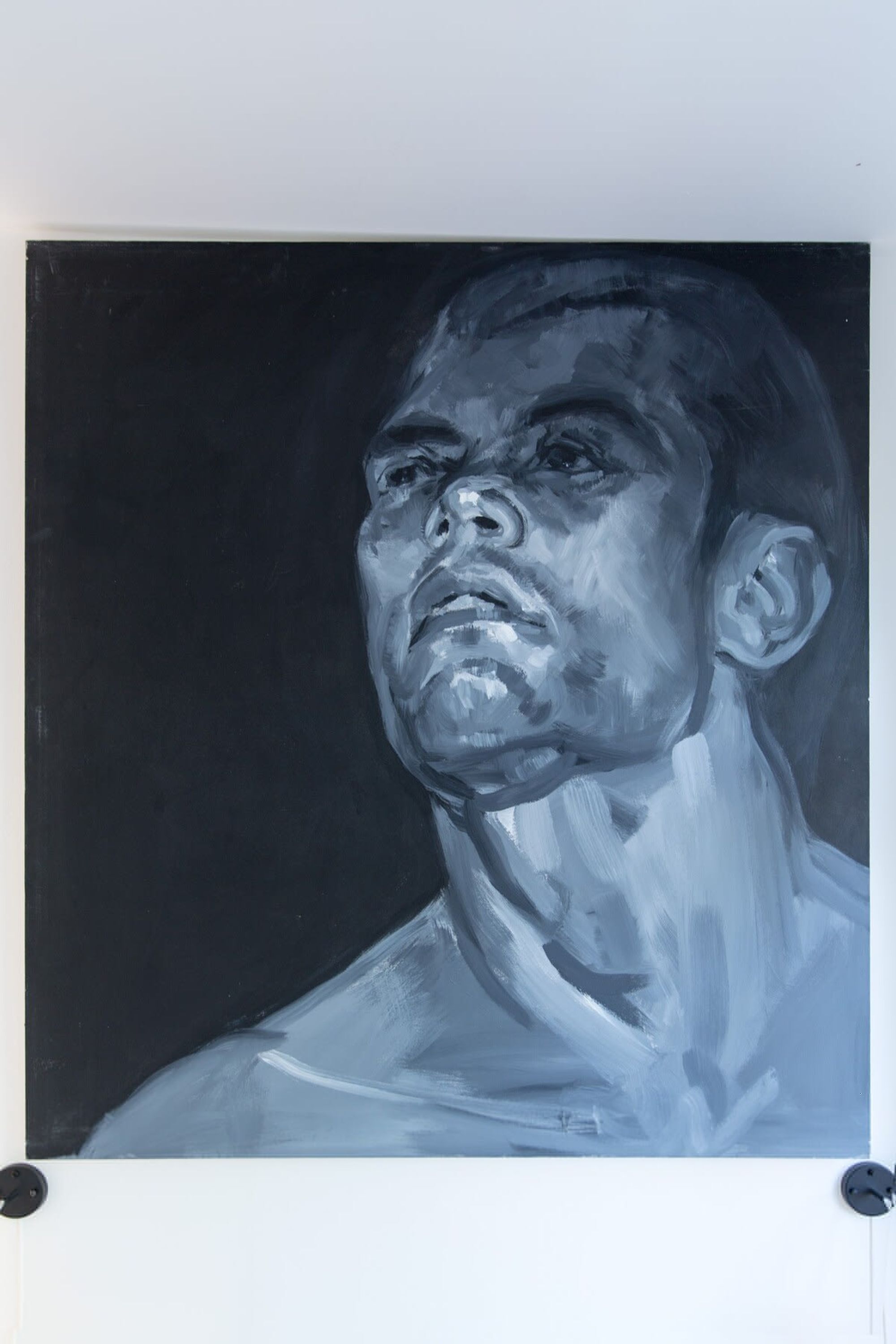 A portrait of a person with a dark background.
