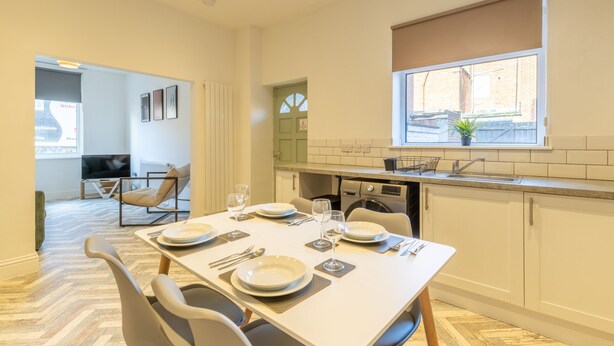 A modern kitchen with a dining area, a TV, and a window with a view. - Anika in South Shields (South Shields)