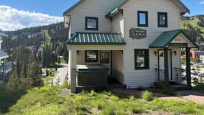 A two-story building with a green roof and a sign that reads 'Star Gazer Chalet.'