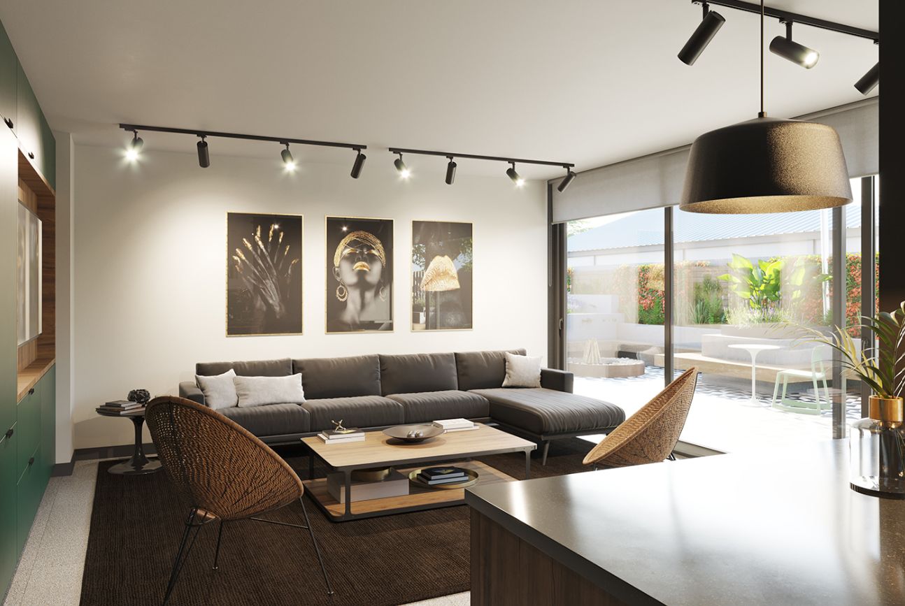 Un salon moderne comprenant un canapé, une table basse et des fauteuils, un coin repas avec une table et des chaises, et des œuvres d’art accrochées aux murs.