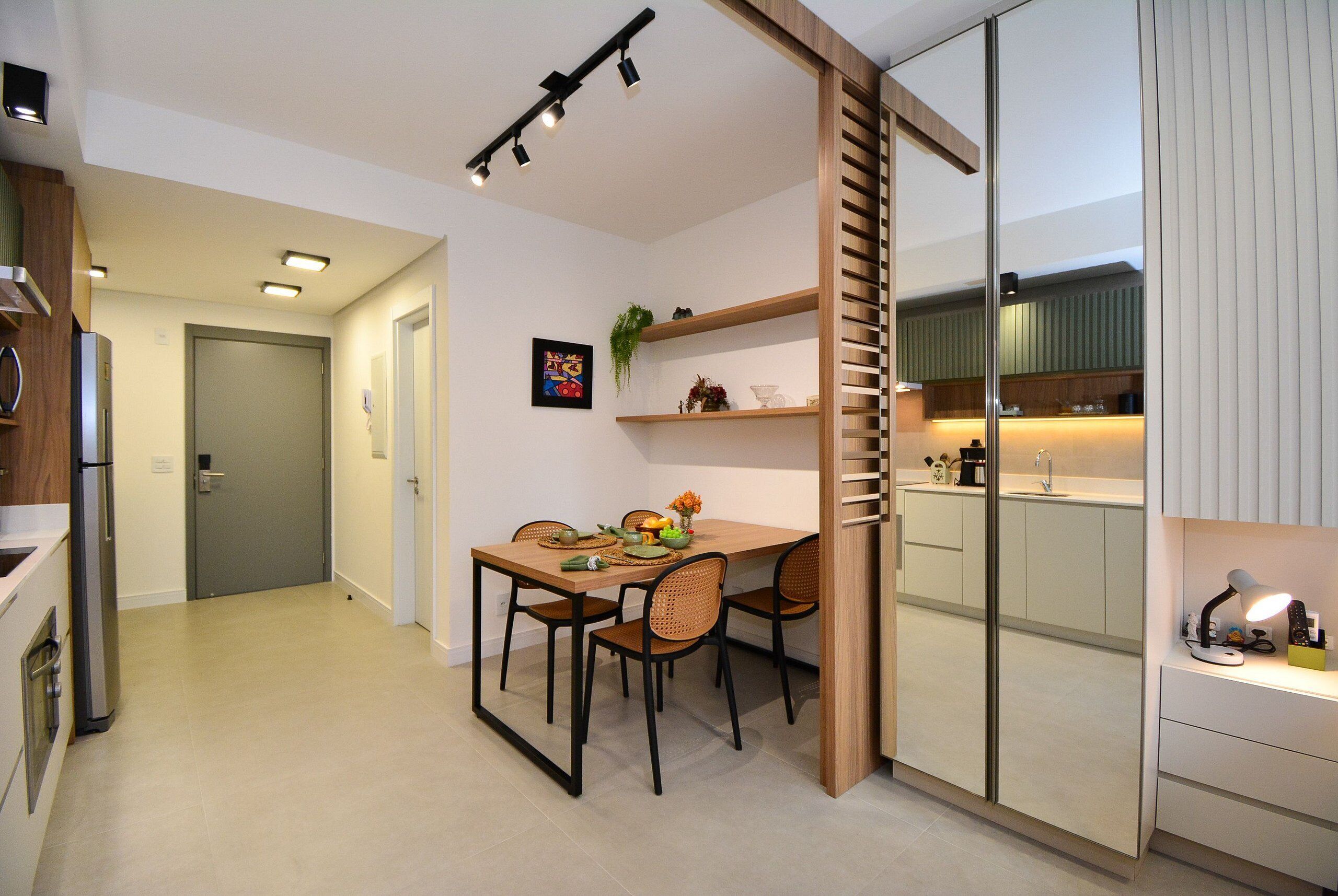 A modern kitchen with a dining area, a refrigerator, and a sink.