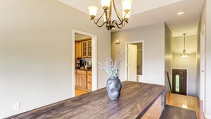 A kitchen with wooden cabinets, a dark wooden countertop, and a vase with flowers. - Waterville Getaway w/ Private Hot Tub (Campton)