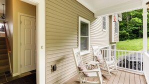 A porch with rocking chairs and a door leading to a staircase. - Waterville Getaway w/ Private Hot Tub (Campton)