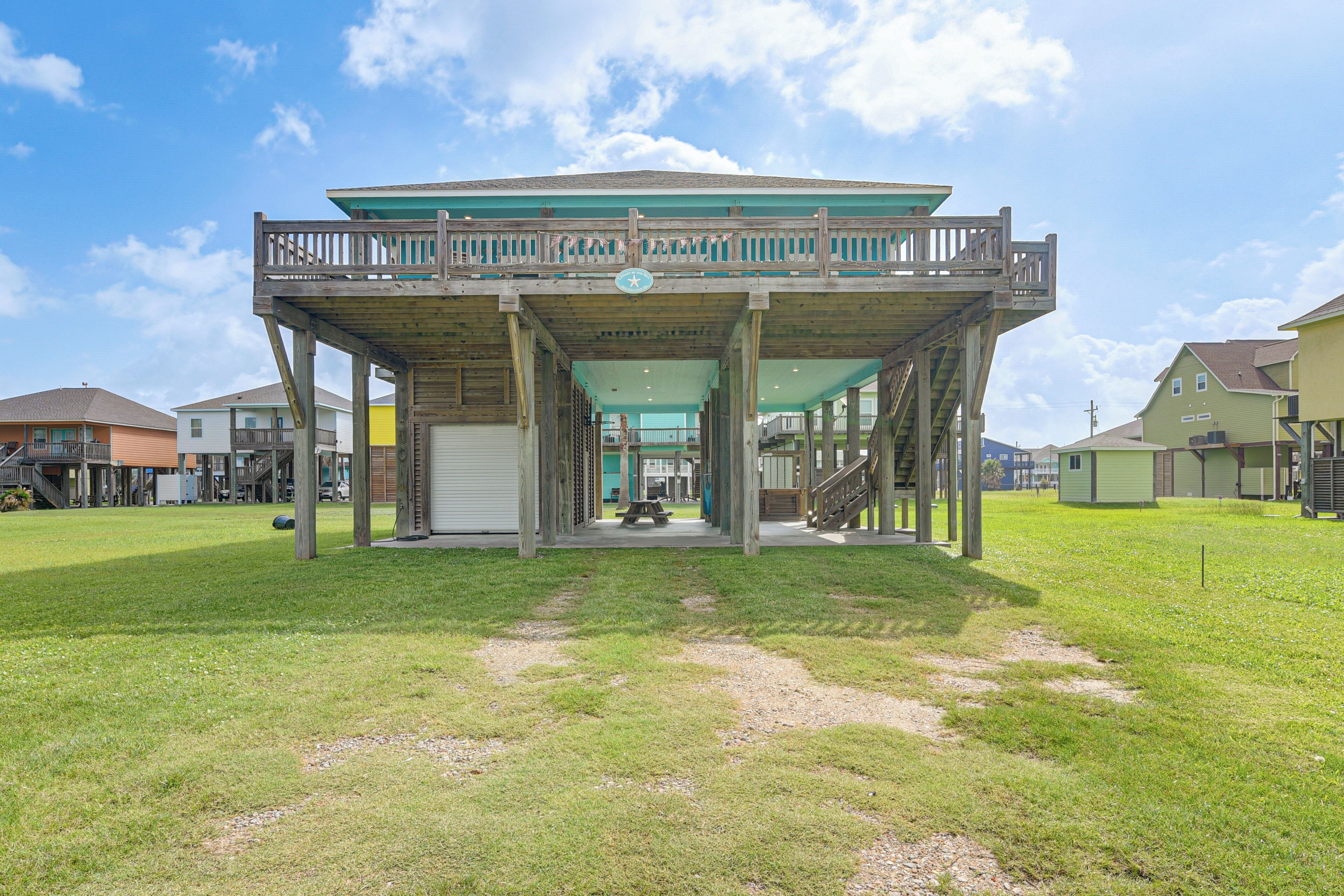 Un edificio con un espacio al aire libre techado, una escalera y una mesa de picnic.