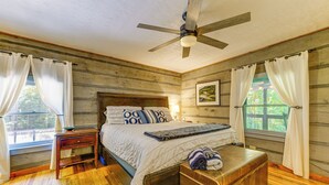 A wooden-paneled bedroom with a bed, bedside table, bench, and ceiling fan. - 7 Acres w/ Trails! Waynesville Adventure Hub (Waynesville)