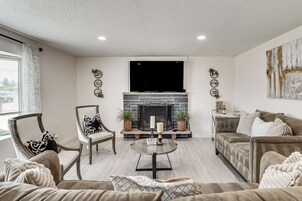 A living room with a fireplace, a television, and a sofa.