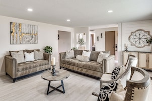 A living room with two sofas, a coffee table, and decorative items.