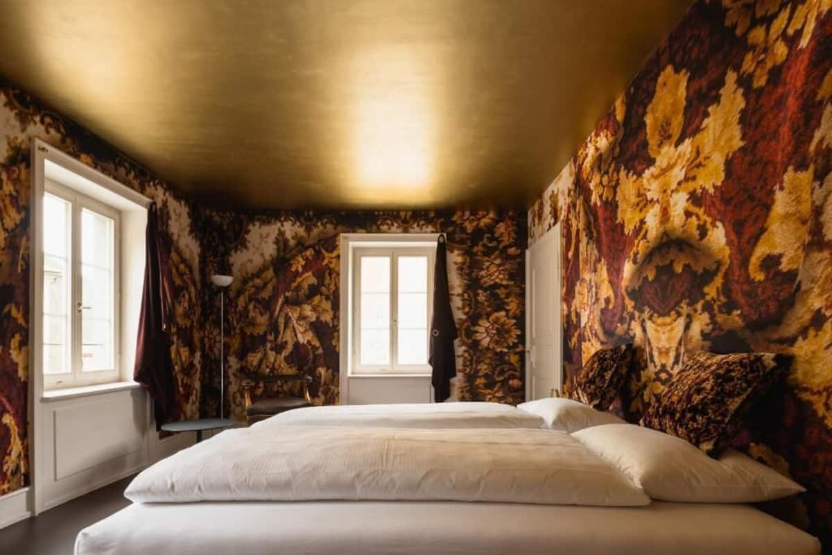 A room with a bed, a window, and a door.