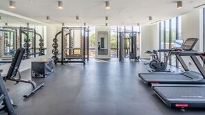 A modern gym with various exercise equipment, large windows, and a clean, spacious layout. - Landing Spectacular Studio, Gym, Pool (Durham)