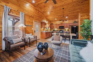 A cozy cabin interior with a living room, dining area, and kitchen. - MT Views Cozy, Well Appointed Hot Tub + Game Room, 1.5 Mi to Downtown, Sleeps 10 (Gatlinburg)