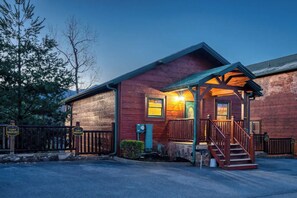 A cabin with a porch and stairs leading to the entrance. - MT Views Cozy, Well Appointed Hot Tub + Game Room, 1.5 Mi to Downtown, Sleeps 10 (Gatlinburg)