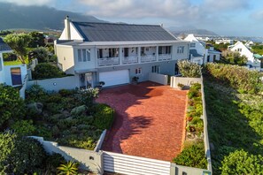 A large, two-story house with a spacious driveway and a well-maintained garden. - Villa Azure, Vermont Home with Studio, Mountain & Sea Views (Vermont)