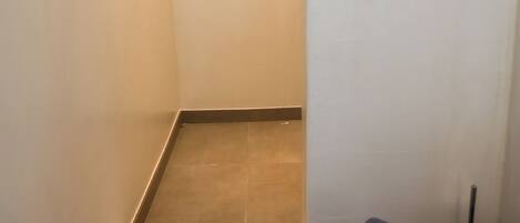 A bathroom with a shower, a towel, and a toilet.