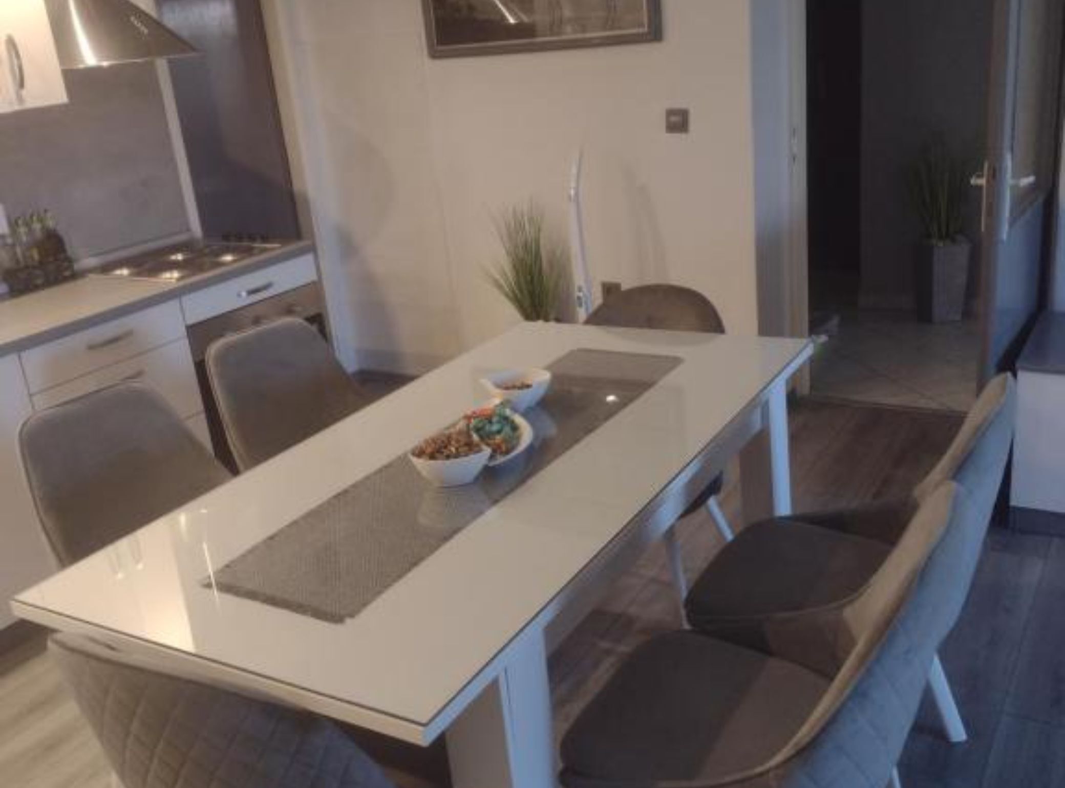 A modern kitchen with a dining area.