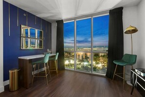 A modern room with a large window, a bar area, and a view of a cityscape. - Hidden Gem! On LV Strip / Lazy River + Free Valet (Las Vegas)