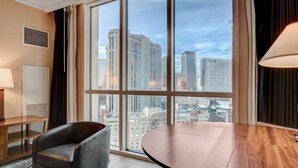 A hotel room with a large window, a desk, a chair, and a lamp. - High Roller Studio On LV Strip-No Resorts Fee! (Las Vegas)