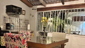 Una zona pranzo con tavolo, sedie e una panca.