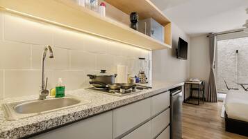 A modern kitchen with a granite countertop, stainless steel appliances, and a built-in dishwasher.