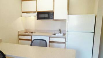 Full-size fridge, microwave, stovetop, cookware/dishes/utensils