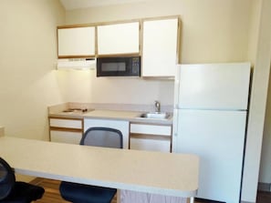 Full-sized fridge, microwave, stovetop, cookware/dishes/utensils