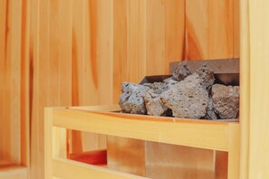 A wooden sauna with a visible compartment containing stones. - 1st Flr Chic Jungle Studio: Priv Pool, Steam & Gym (Tulum)