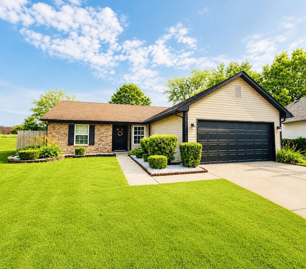 A single-story house with a front yard, a garage, and a small porch.