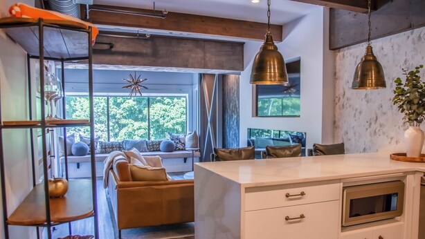 A modern kitchen with white cabinetry, a built-in oven, and pendant lighting. - LUXURY DOWNTOWN WATERFRONT RETREAT with Park, Lake and Marina Views (Kelowna)