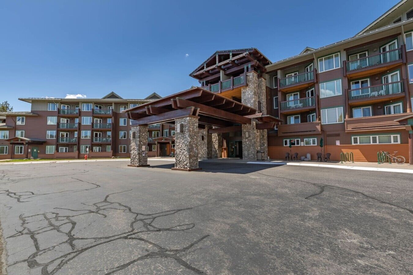 A multi-story hotel with a stone entrance and balconies.