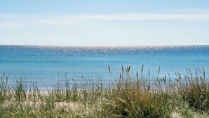 Una spiaggia con acque cristalline e un orizzonte lontano.