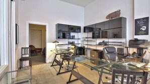 A modern office space with a glass table, black office chairs, and a desk with a computer. - Unique  loft like Apt with cache.. in 3 story small 3 unit warehouse conversion. (Montréal)