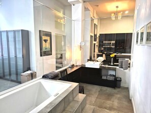 A modern bathroom with a bathtub, a vanity with a sink, and a shower area. - Unique  loft like Apt with cache.. in 3 story small 3 unit warehouse conversion. (Montréal)