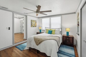 A bedroom with a bed, bedside lamps, a ceiling fan, and a window with blinds. - Nokomis Sunset Retreat  w/Pool - 8 mins to Beach (Nokomis)