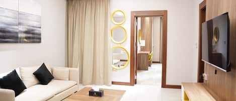 Luxury Suite, Balcony, City View | Living room | Smart TV, streaming services, computer monitors, printers
