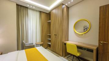 Deluxe Suite, City View | In-room safe, blackout drapes, soundproofing, iron/ironing board