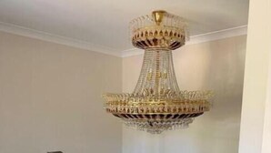 A staircase with glass railings and a chandelier. - Luxury Fully Furnished Acreage Retreat – Dural (Dural)