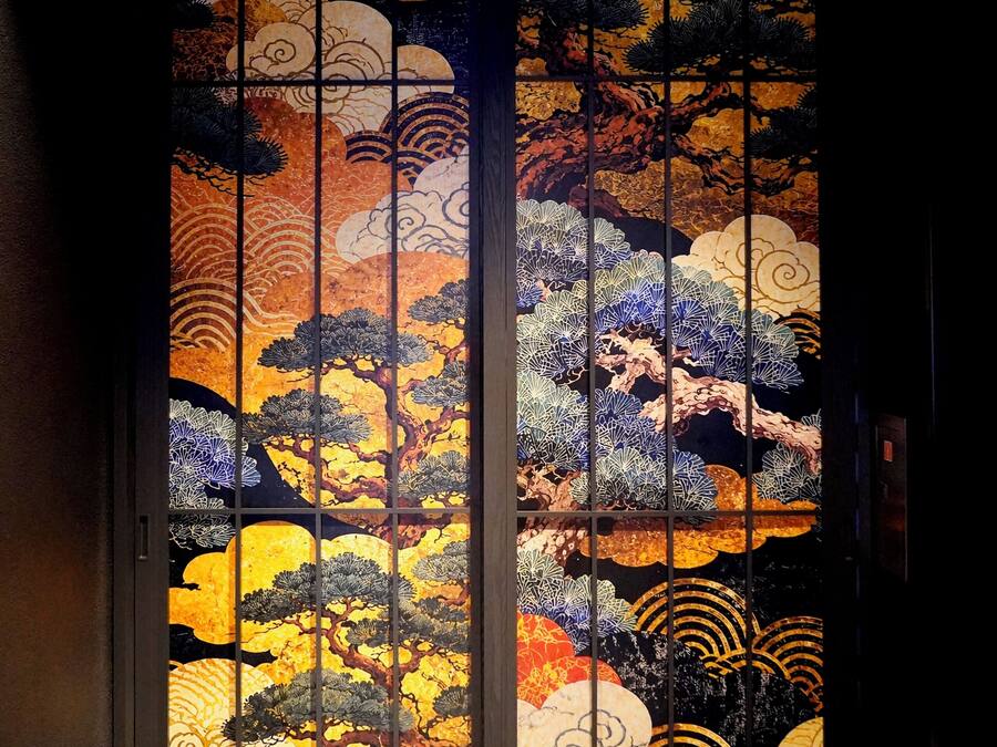 A traditional Japanese sliding door with intricate artwork.