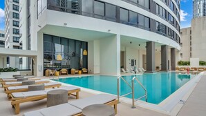 A modern indoor pool area with lounge chairs and a pool. - Bright & Modern Downtown Miami stay- 10th floor- 2B/2B (Miami)