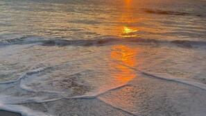 A beach scene with waves and sunlight reflecting on the water. - The Coastal Oak - Pool | Linen and Towels | Pets | Wifi (Carrickalinga)