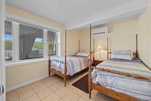 A bedroom with two wooden beds, a window with a view, and a ceiling fan. - Waterfront Memories Begin at Deckside on Keuka! (Dundee)