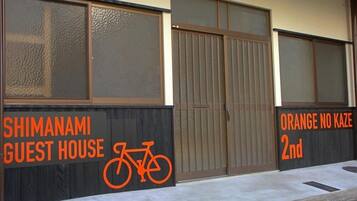 A guest house named 'SHIMANAMI GUEST HOUSE' with a bicycle symbol, indicating bike-friendly accommodation.