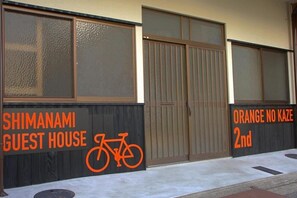 A guest house named 'SHIMANAMI GUEST HOUSE' with a bicycle symbol, indicating bike-friendly accommodation.