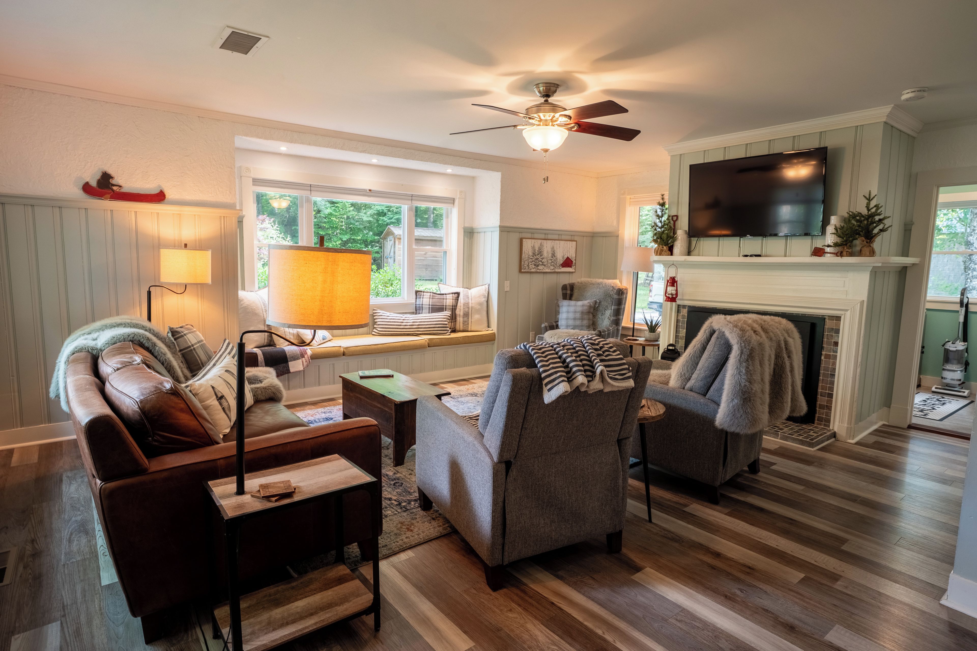 A cozy living room with a fireplace, a television, and a comfortable seating area.