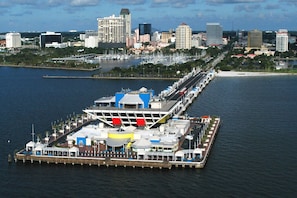 A waterfront pier with a large building, possibly a hotel or restaurant, featuring multiple decks and a long walkway. -  Three Palms 3BR / sleeps 8 / beach 5 min. / backs to nature trail & park w/lake (Largo)