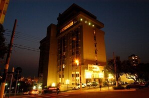 A multi-story building with large windows and a sign indicating a hotel. - Charming Space w/ Laqueada Wood Decor + “O Desbravador” Nearby (Santa Catarina)