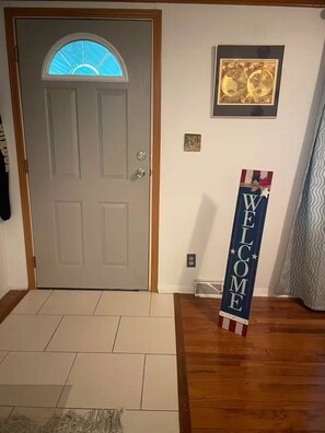 A door with a window, a welcome sign, a framed picture, and a patterned rug. - Private 1-BR Ensuite with Separate Entrance I 5min DT Jonesborough (Jonesborough)