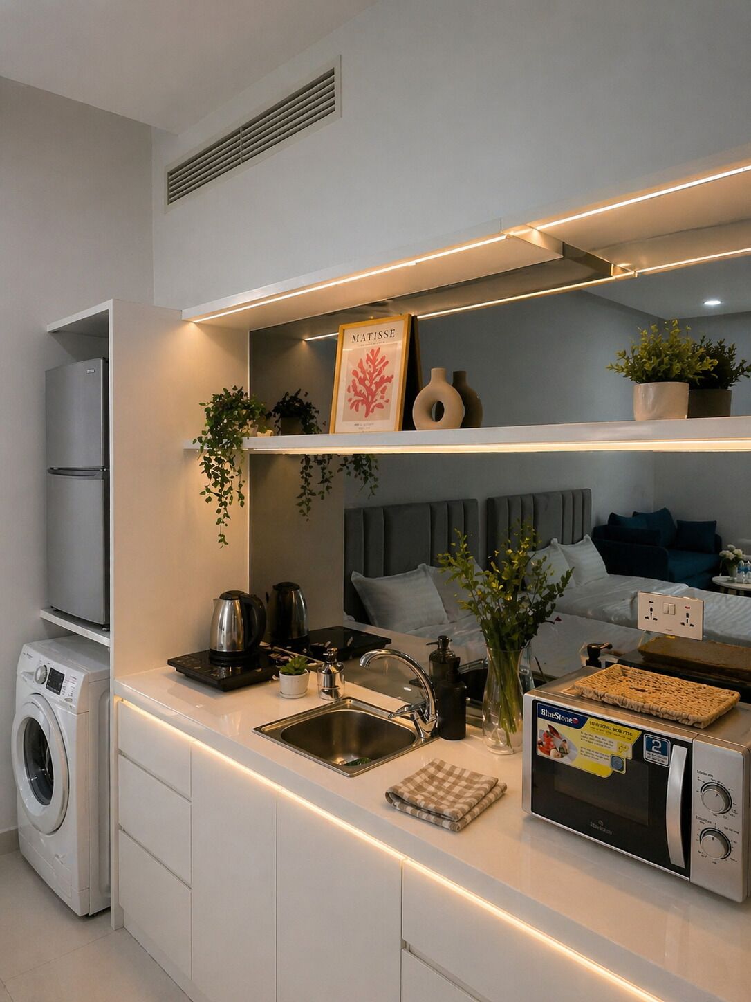 A modern kitchen with built-in appliances, a sink, and a microwave.