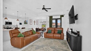 A modern living room with a sofa, a TV, and a console table.