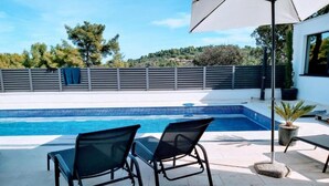 A swimming pool with two lounge chairs and a patio umbrella. - Sunset Villa Aves With Pool, Gym and Sauna - Four Bedroom Villa (Rogac)