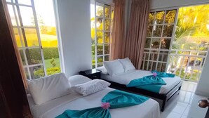 A hotel room with two beds, large windows, and a view of greenery. - El Amanecer Farm Hotel (Quimbaya)